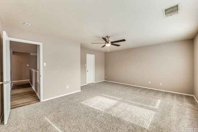 unfurnished bedroom featuring a textured ceiling, ceiling fan, and carpet flooring