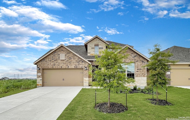 view of front facade with a garage and a front lawn