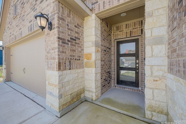 doorway to property with a garage