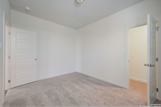 empty room featuring light colored carpet