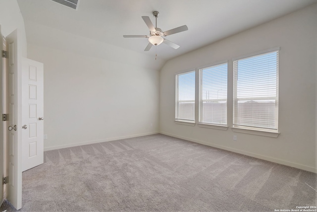 carpeted spare room featuring ceiling fan