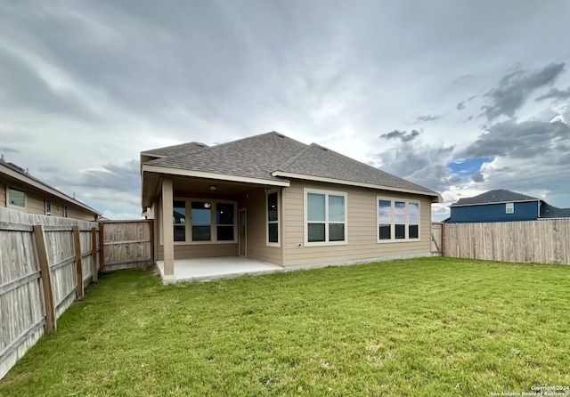 back of property featuring a yard and a patio area