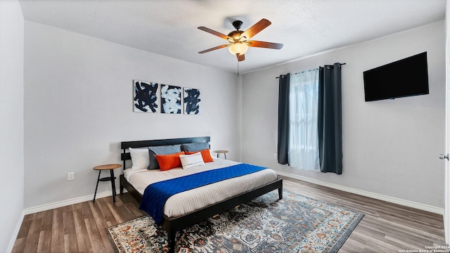 bedroom with hardwood / wood-style floors and ceiling fan