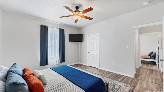 bedroom with ceiling fan and light hardwood / wood-style floors