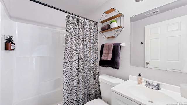 full bathroom featuring shower / bath combo, vanity, and toilet