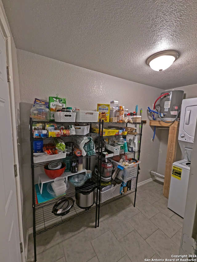 storage room featuring stacked washer / drying machine