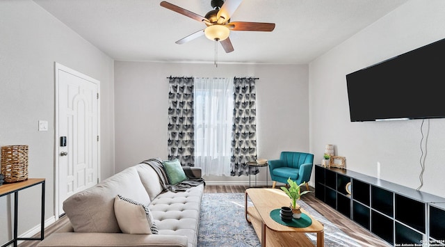 living room featuring hardwood / wood-style floors and ceiling fan