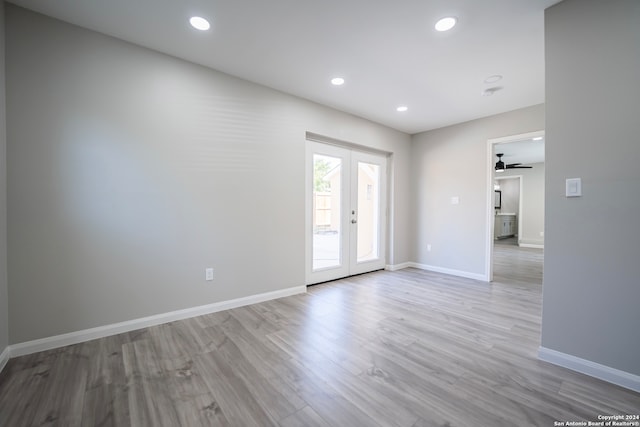 spare room with ceiling fan, french doors, and light hardwood / wood-style floors