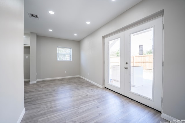 doorway to outside featuring french doors and light hardwood / wood-style floors