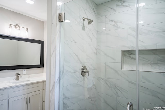 bathroom with vanity and a shower with shower door