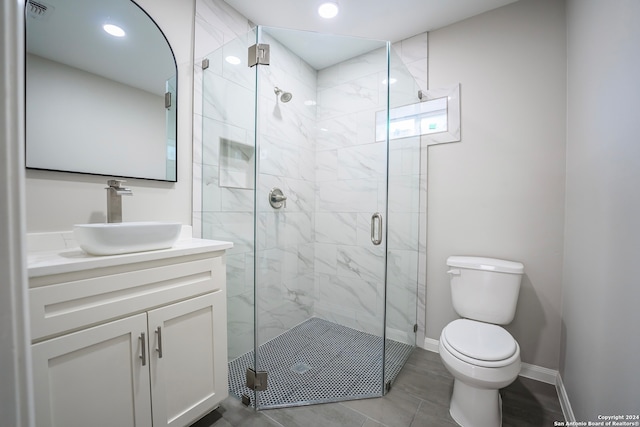 bathroom featuring walk in shower, vanity, toilet, and tile patterned floors