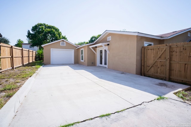 view of front of property with french doors and a garage