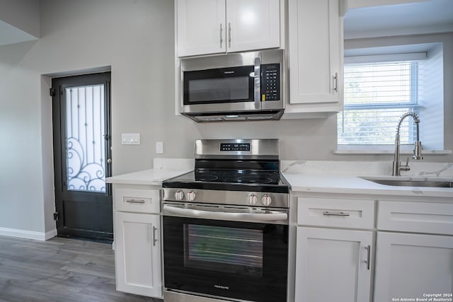 kitchen with white cabinets, stainless steel appliances, and sink