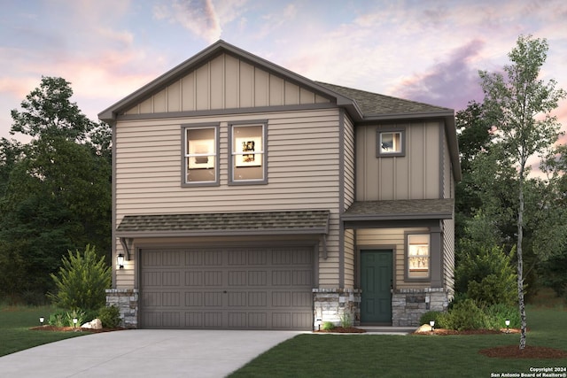 craftsman inspired home featuring a garage and a lawn