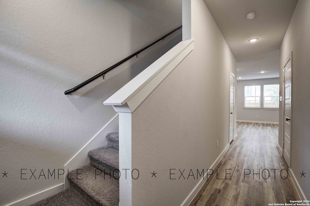 staircase featuring hardwood / wood-style floors