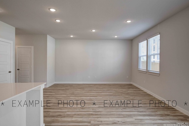 unfurnished room with light wood-type flooring