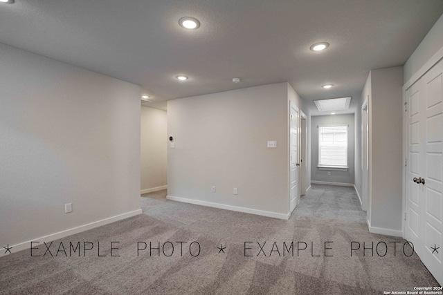 empty room featuring light carpet