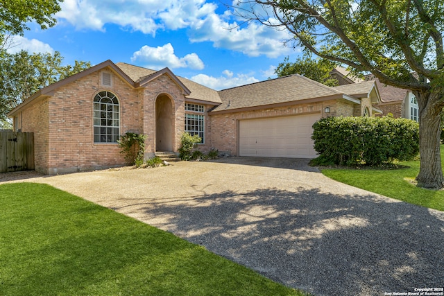 single story home with a front lawn and a garage