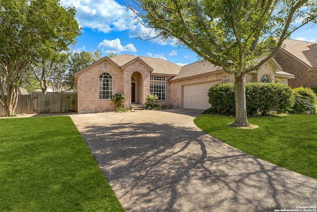 ranch-style house featuring a garage and a front lawn