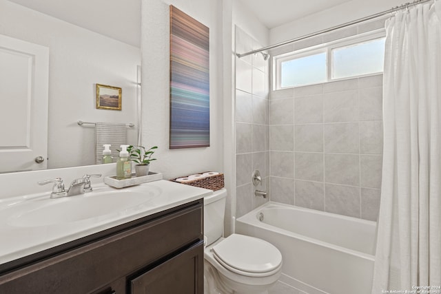 full bathroom with vanity, shower / bath combo with shower curtain, and toilet