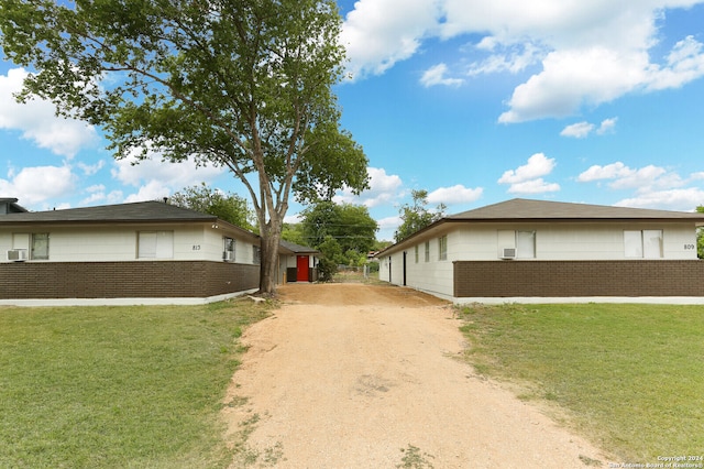 view of side of home featuring a lawn