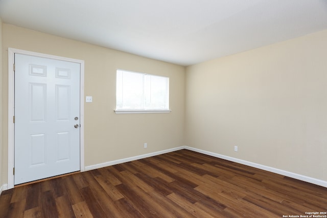 empty room with dark wood-type flooring