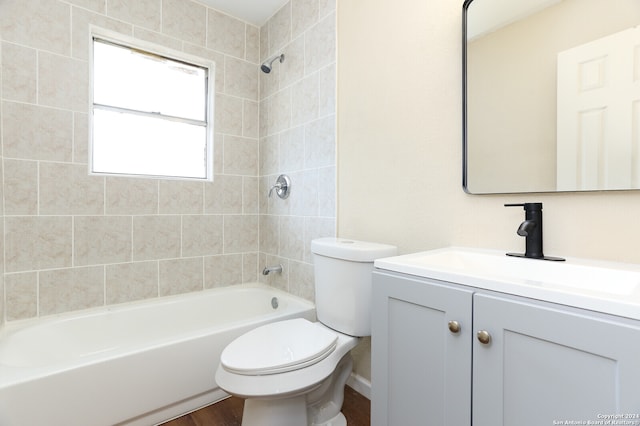 full bathroom with hardwood / wood-style flooring, vanity, toilet, and tiled shower / bath combo