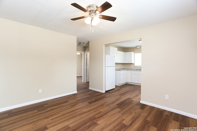 unfurnished living room featuring dark hardwood / wood-style flooring and ceiling fan