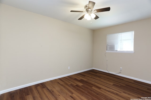 spare room with dark wood-type flooring and ceiling fan