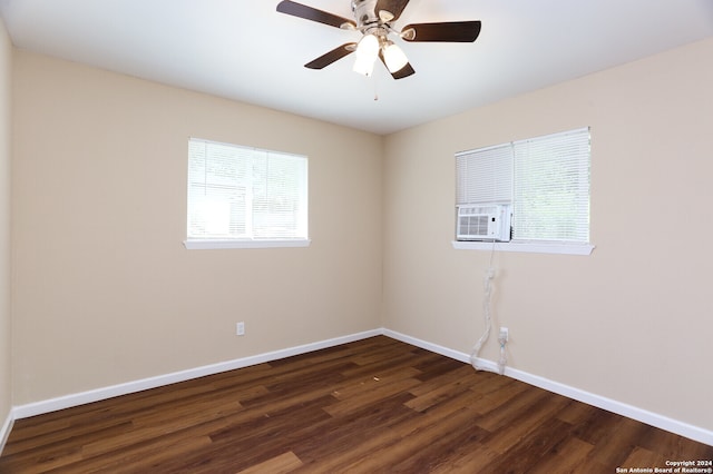 unfurnished room featuring ceiling fan, cooling unit, and dark hardwood / wood-style flooring