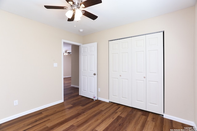 unfurnished bedroom featuring ceiling fan, dark wood-type flooring, and a closet