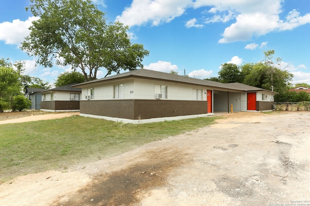 ranch-style home featuring a front yard and a carport