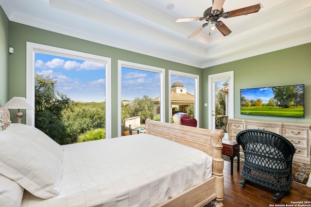 bedroom with ceiling fan, access to outside, a raised ceiling, wood-type flooring, and crown molding