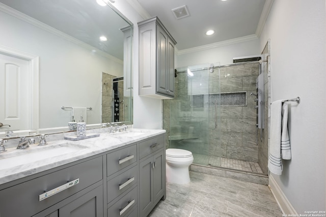 bathroom featuring crown molding, a shower with door, vanity, and toilet