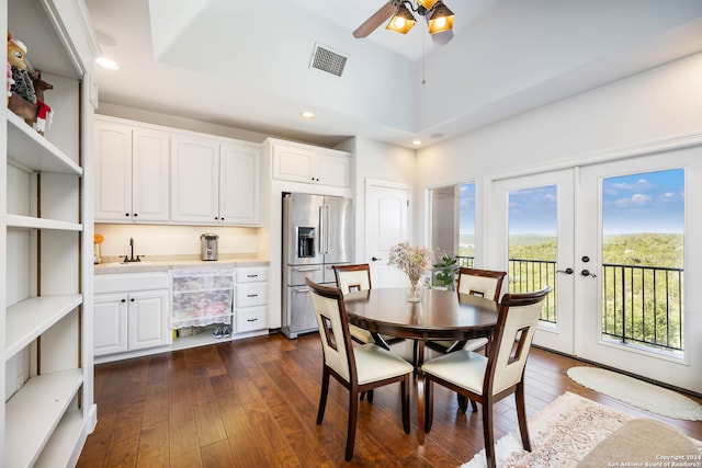 dining area with french doors, dark hardwood / wood-style floors, a towering ceiling, and ceiling fan