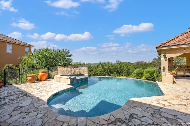 view of pool featuring an in ground hot tub and a patio area