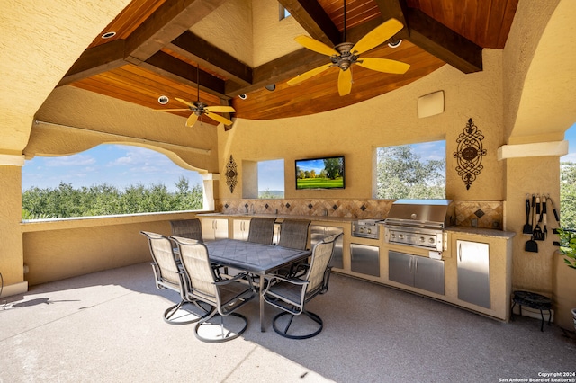 view of patio / terrace with exterior kitchen, ceiling fan, and grilling area