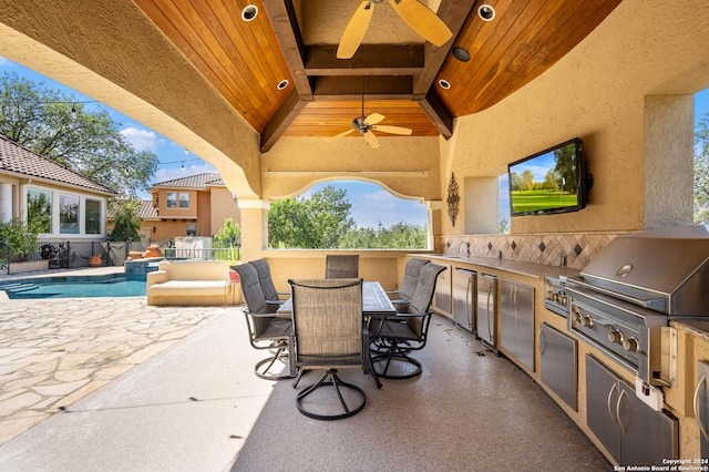 view of patio / terrace featuring ceiling fan, grilling area, and an outdoor kitchen