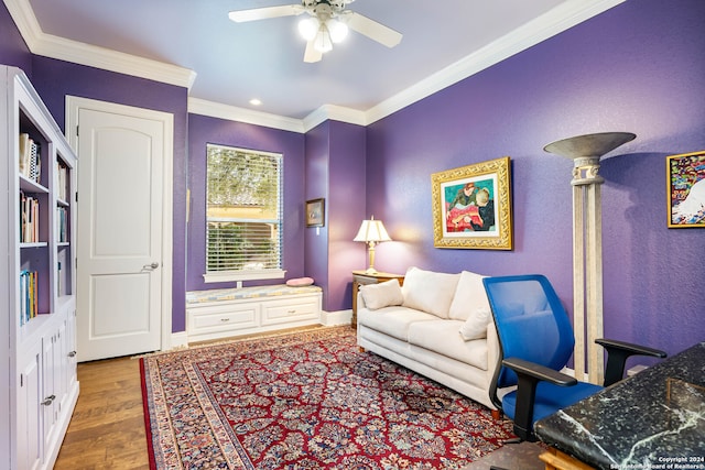 living area with crown molding, ceiling fan, and dark hardwood / wood-style flooring