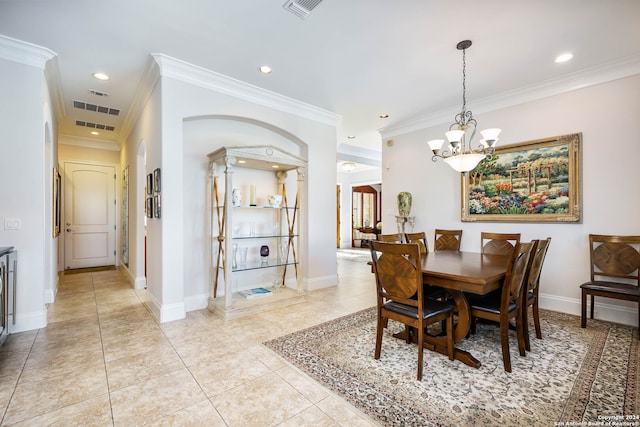 dining area with ornamental molding, light tile patterned floors, and a chandelier