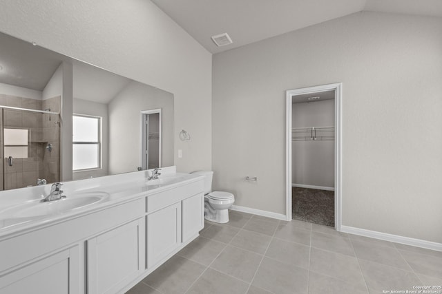 bathroom with vanity, lofted ceiling, tile patterned flooring, toilet, and a shower with shower door