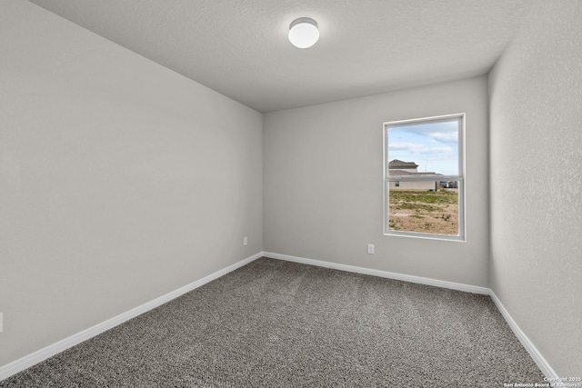 spare room featuring carpet flooring and a textured ceiling