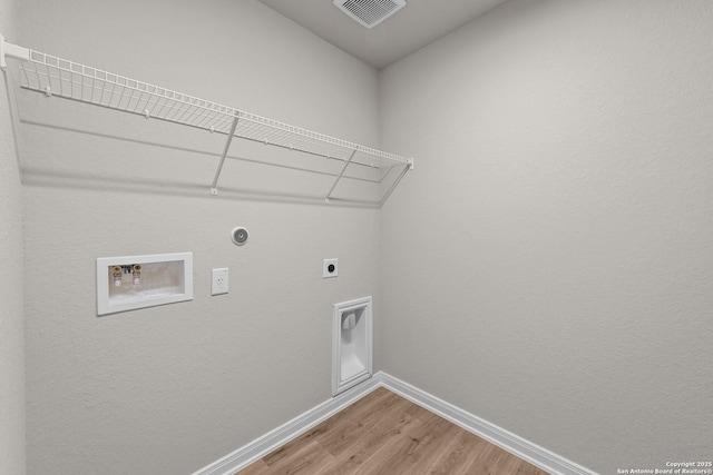 washroom with washer hookup, electric dryer hookup, gas dryer hookup, and hardwood / wood-style flooring