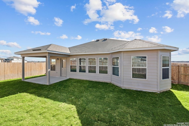 rear view of house with a yard and a patio