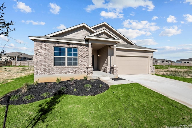 craftsman house with a garage and a front lawn