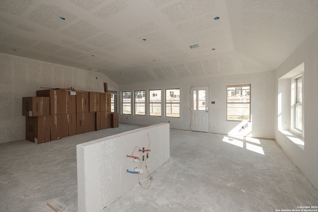 interior space with a healthy amount of sunlight and vaulted ceiling