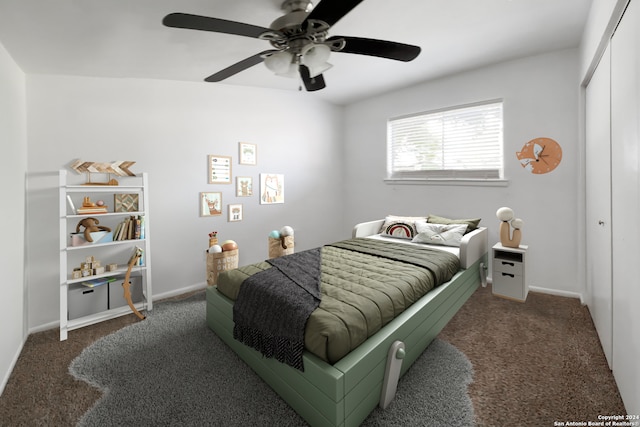 carpeted bedroom featuring a closet and ceiling fan