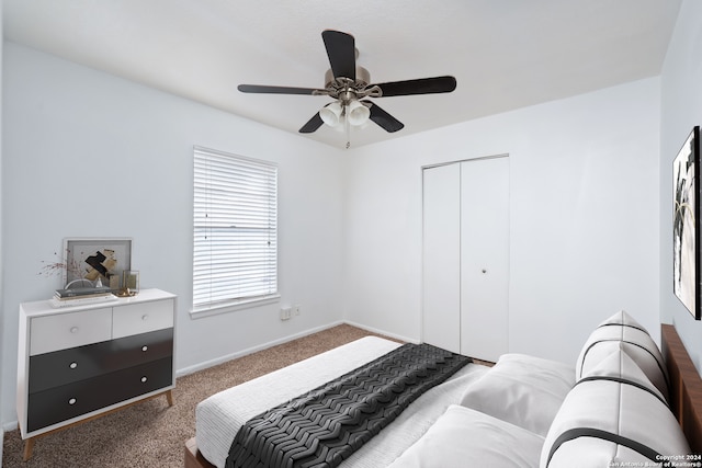 bedroom featuring ceiling fan, a closet, and dark carpet