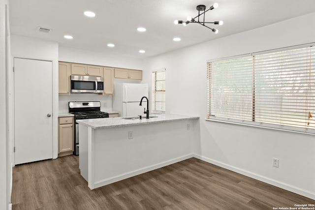 kitchen featuring a chandelier, dark wood-type flooring, light brown cabinets, sink, and appliances with stainless steel finishes