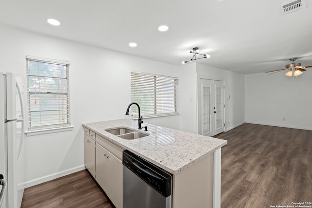 kitchen featuring white fridge, a healthy amount of sunlight, dark wood-type flooring, and dishwasher